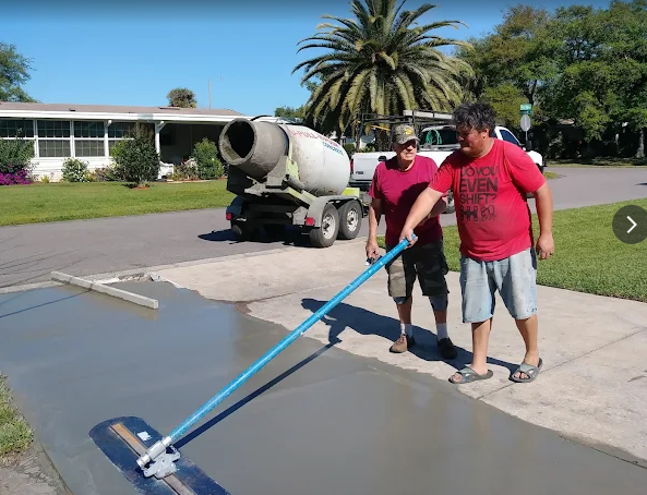 Bull float finishing on a fresh driveway pour