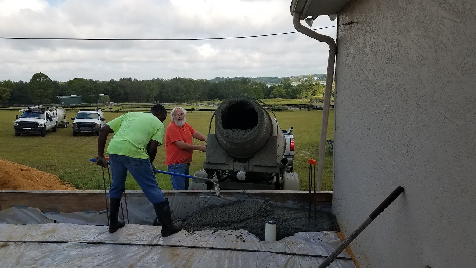Crew pouring concrete at a residential site